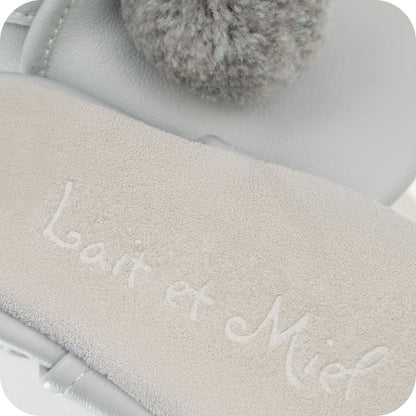 Baby booties with pompoms Grey
