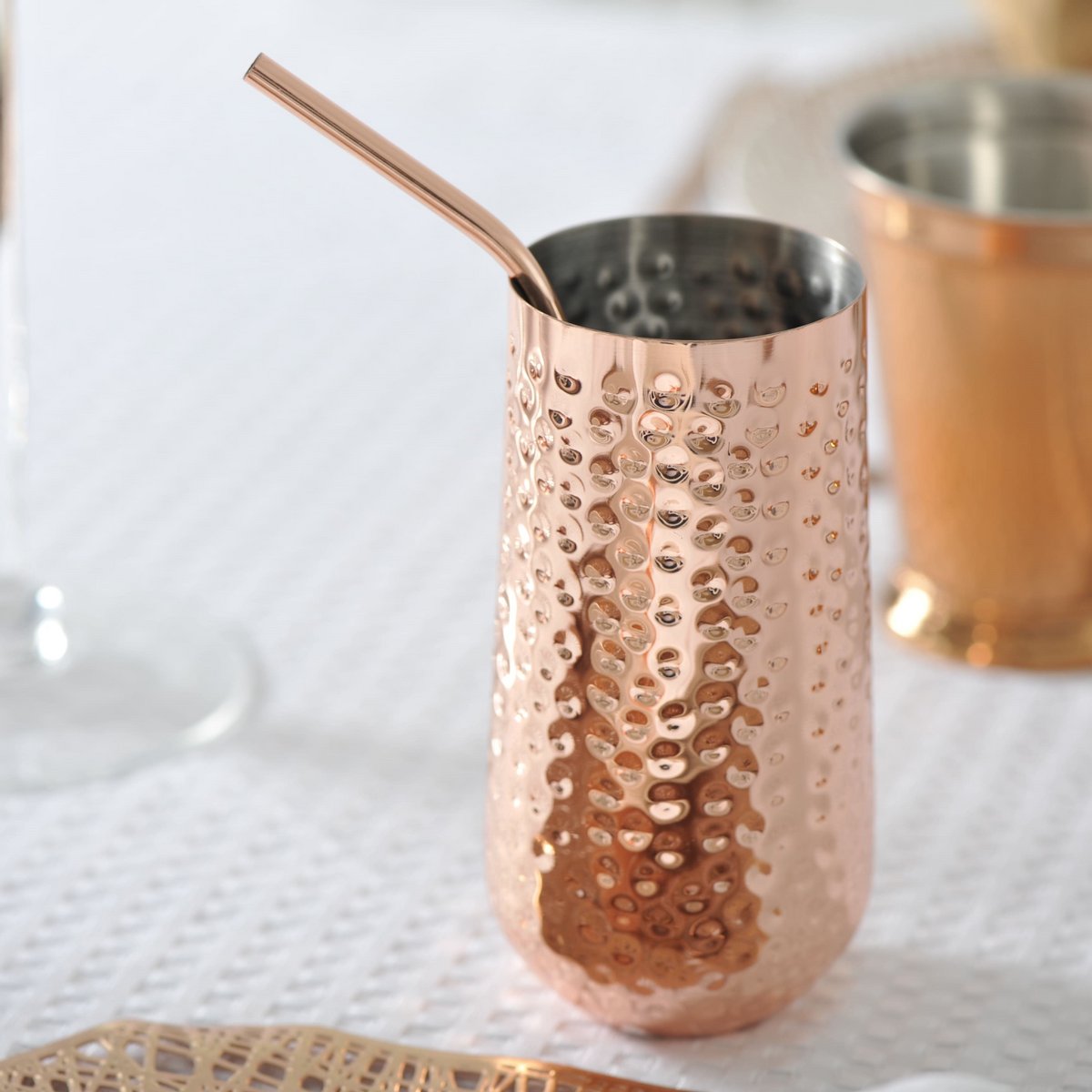 Cocktail glass with copper straw