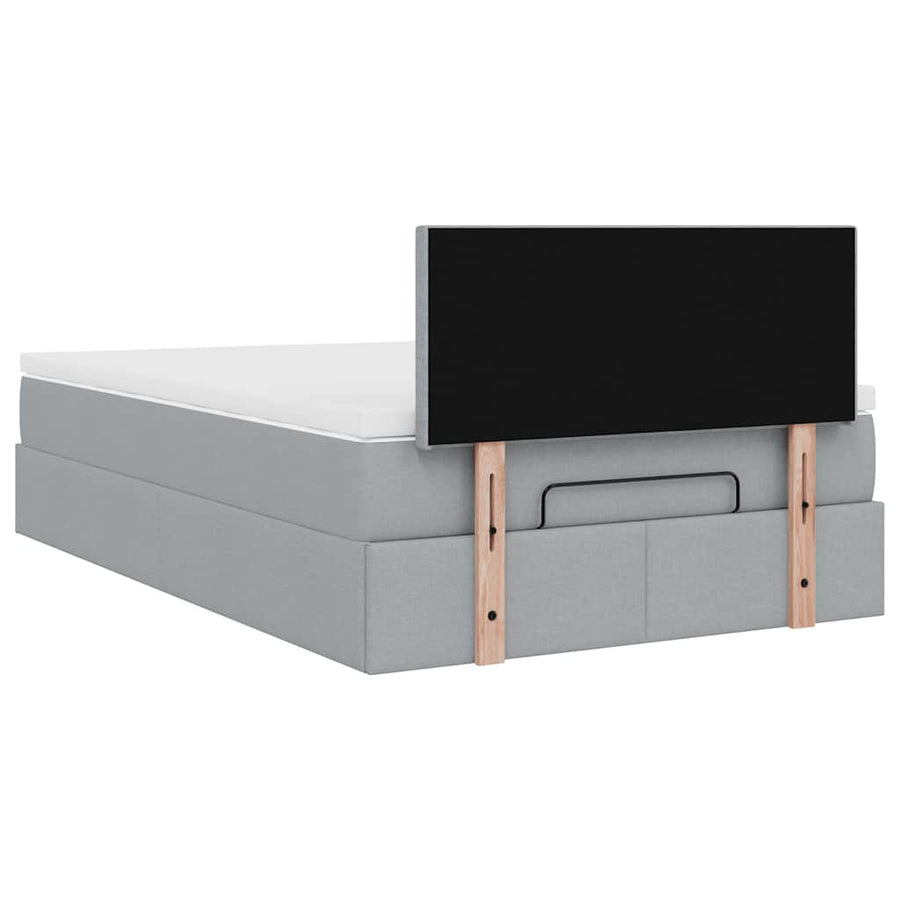 Ottoman bed met matras en LED's 120x200 cm stof lichtgrijs