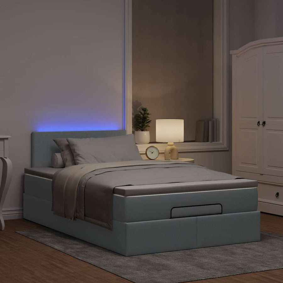 Ottoman bed met matras en LED's 120x200 cm stof lichtgrijs
