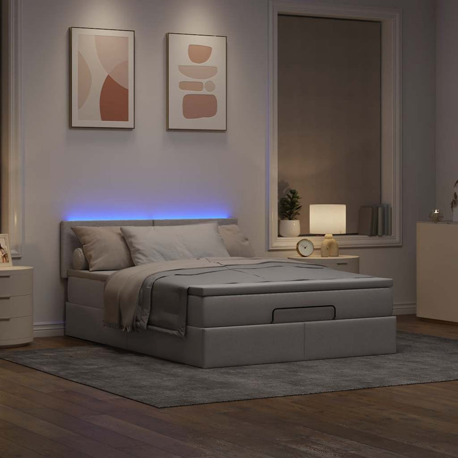 Ottoman bed met matras en LED's 140x200 cm stof taupe