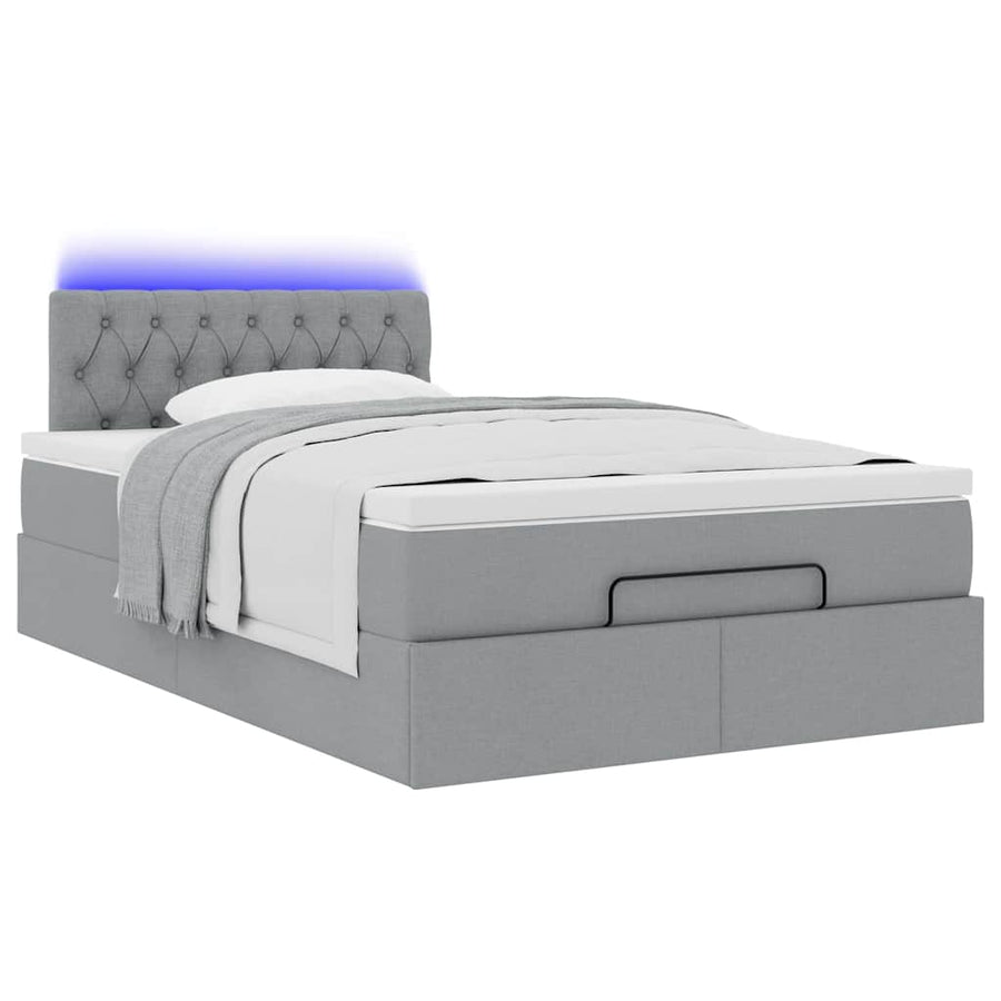 Ottoman bed met matras en LED's 120x200 cm stof lichtgrijs