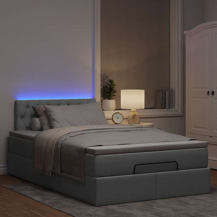 Ottoman bed met matras en LED's 120x200 cm stof lichtgrijs