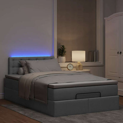 Ottoman bed met matras en LED's 120x200 cm stof lichtgrijs