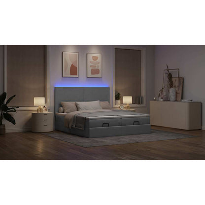 Ottoman bed met matrassen en LED's 180x200cm stof lichtgrijs