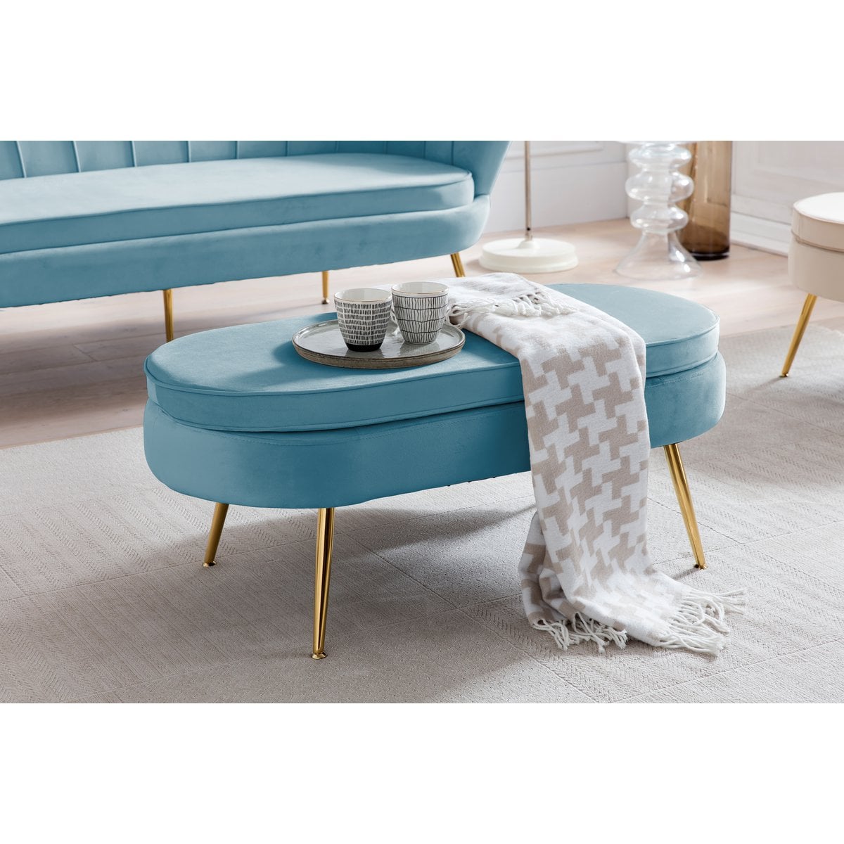 Oval ottoman made of blue velvet
